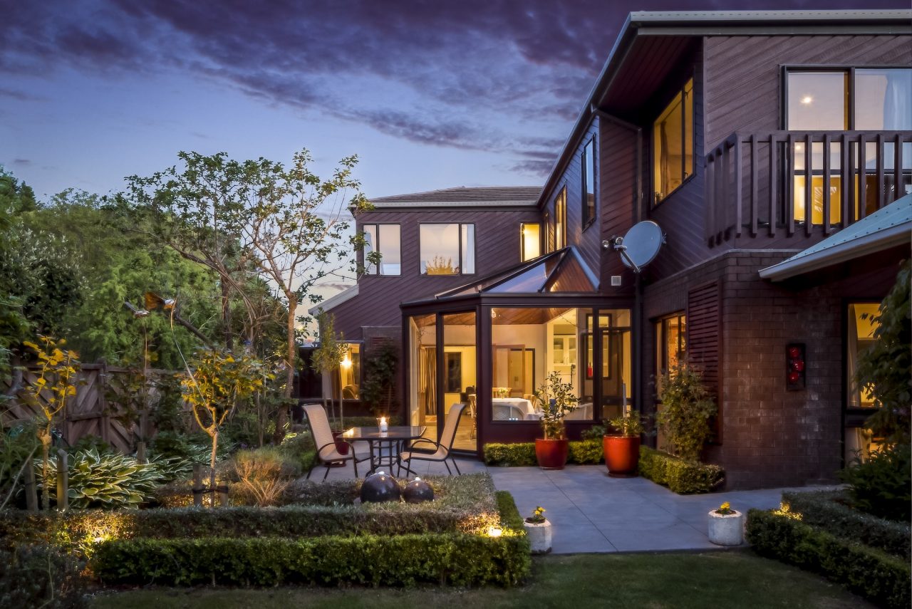 big-private-house-with-a-garden-under-the-cloudy-sky-at-night.jpg